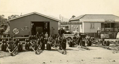 old sepia photo of Rinaudo Engineering with workers posing next to equipment